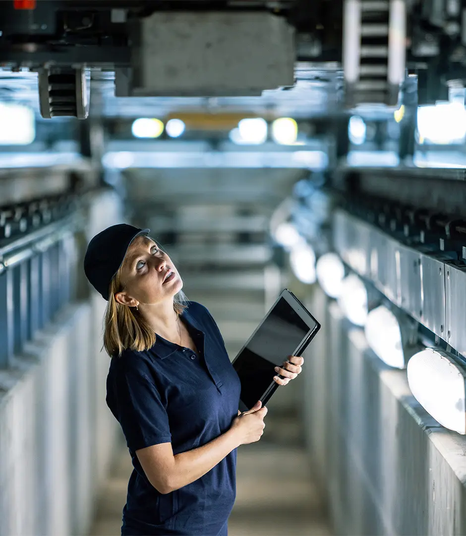 A service employee stands under a train and carries out an inspection